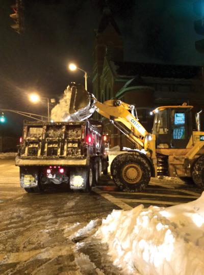 Plows work in the pile at Columbia Road and Dorchester Avenue. 	City of Boston photo